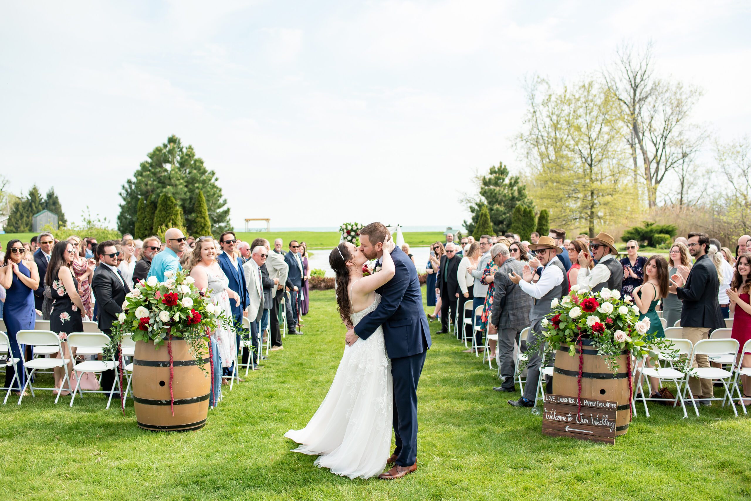 Couple kissing at the end of the aisle at Sprucewood Shores Estate Winery.