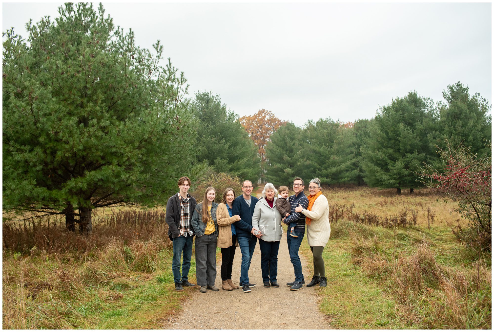 Extended family looking at the camera and smiling at Komoka Provincial Park.