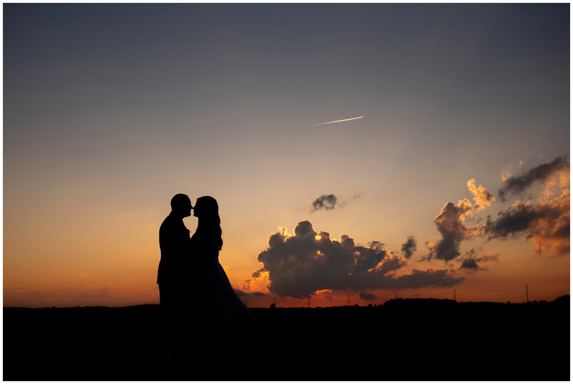 Couple silhouette at sunset on their wedding day in Malahide Ontario.